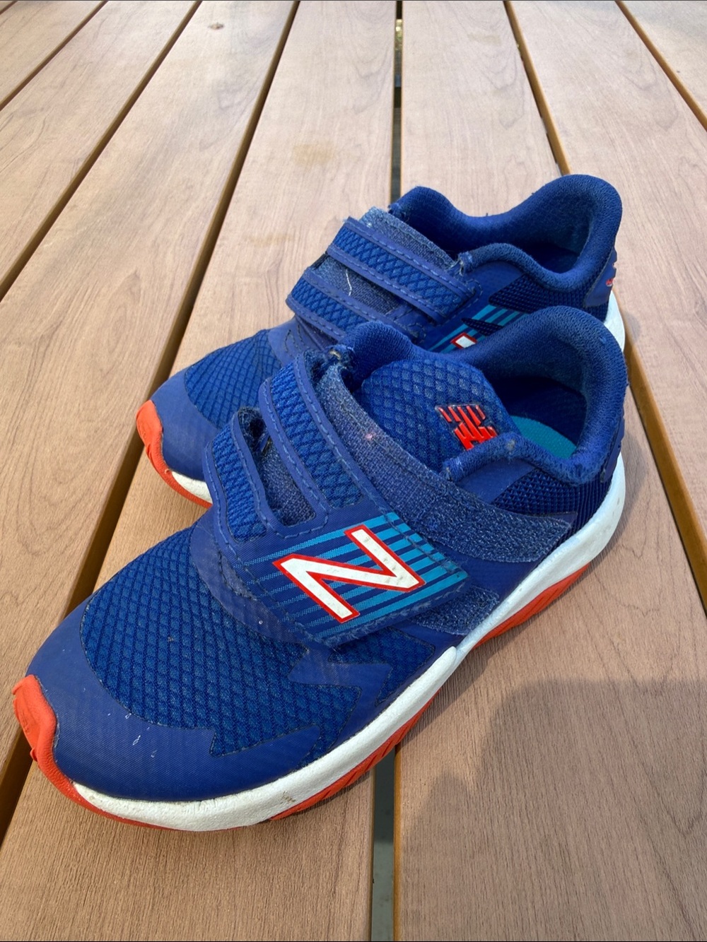 New Balance Kids Blue Sneakers with Orange Accents
